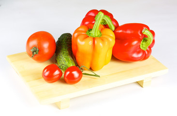 fresh and juicy vegetables on the wood plate isolated