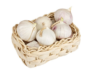 Several garlic onions in a basket isolated