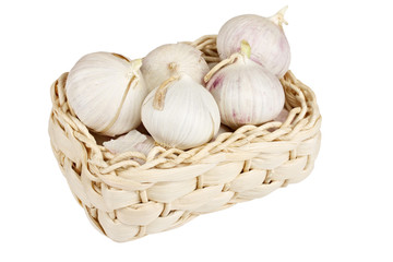 Several garlic onions in a basket isolated