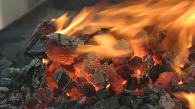 Close-up of glowing hot embers outdoors