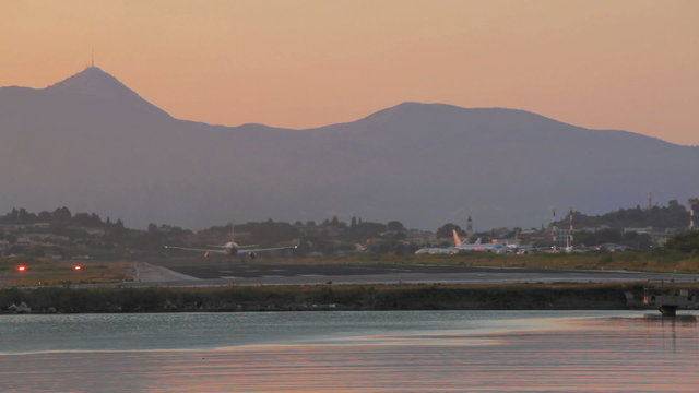 Take-off of airplane in Corfu airport during sunset, Greece