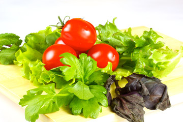 fresh and juicy vegetables on the wood plate isolated
