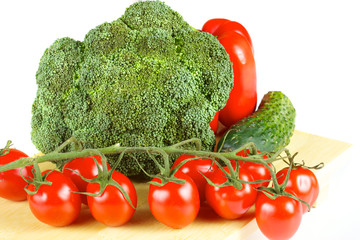 fresh and juicy vegetables on the wood plate isolated