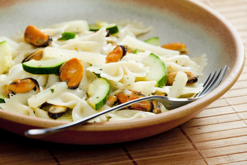 pasta farfalle with mussels and zucchini