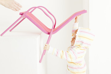 portrait of toddler with a chair