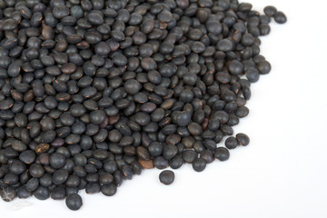 Heap of black lentil isolated on white