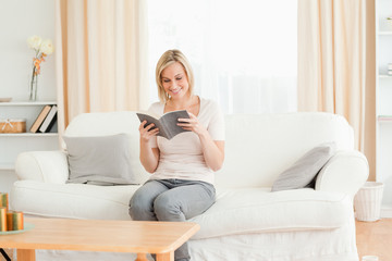 Fototapeta premium Blond-haired woman reading a book