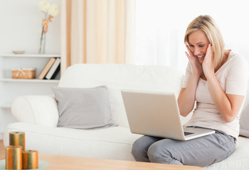 Happy woman looking at her laptop