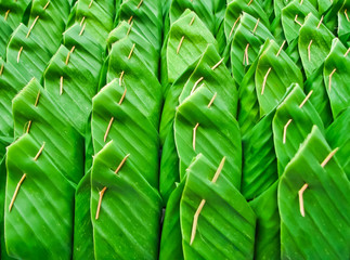row of Thai dessert in banana leaf package