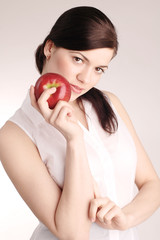 Young beautiful woman with red apple