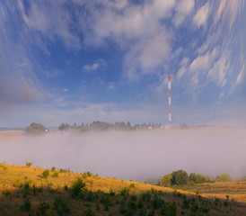 Communication antenna at foggy summer morning