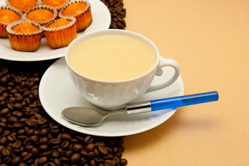 White cup of coffee and coffee beans