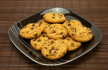 plate of cookies on dark brown background