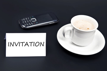 Fototapeta na wymiar Invitation message on desk with coffee