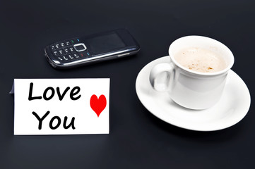 Love you message on desk with coffee