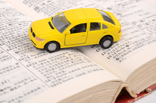 Toy car on open book