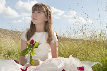 girl wearing first communion dress in the meadow