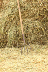 pitchfork standing on a pile of straw