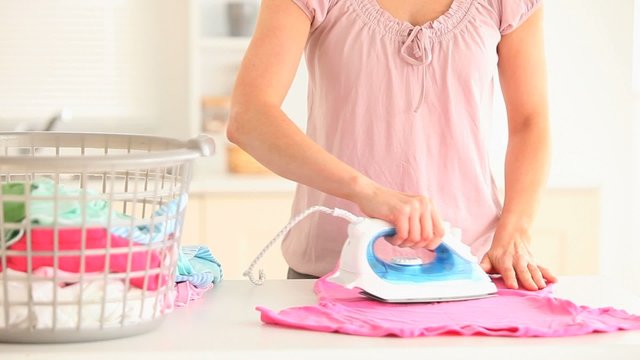 Housewife ironing a T-shirt