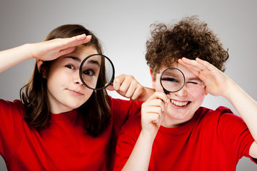 Girl and boy holding magnifying glass © Jacek Chabraszewski