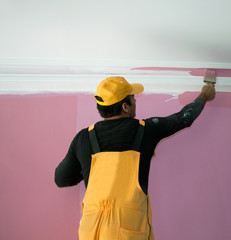 painting a wall pink by painters construction workers