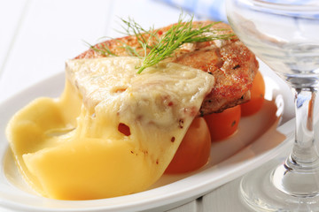 Marinated pork chop topped with cheese
