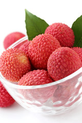 fresh lychees in glass bowl on white background
