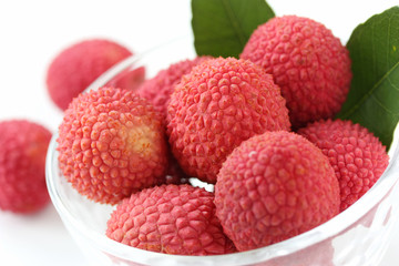 fresh lychees in glass bowl on white background