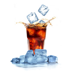 Cola with ice cubes splashing