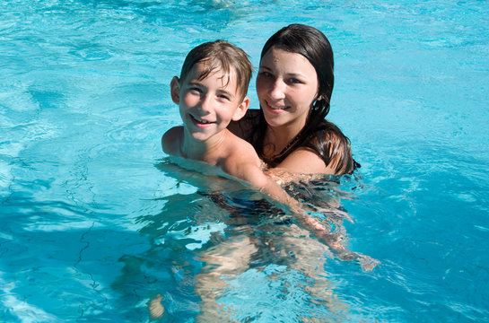 Smiling children in the swimming pool