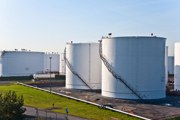 white tanks in tank farm with blue sky
