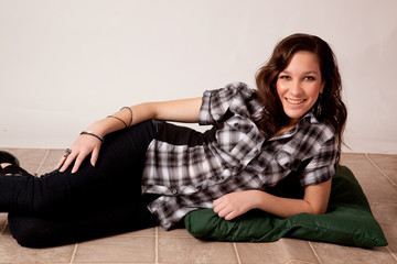 Pretty white woman reclining on the floor