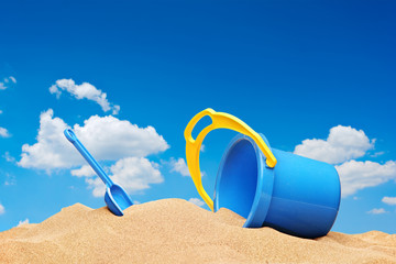A view of a bucket and scoop at the beach