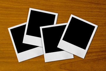 blank photo frames on a wood background