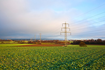 electrical tower in landscape with dark clouds