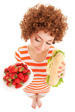 Fun woman with strawberry and sandwich on the white background