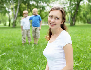 Fototapeta premium Portrait of mother with two sons on the background