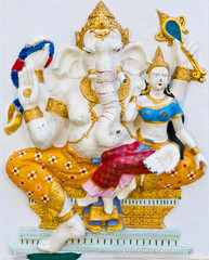 Golden dresses ganesha with angel on white wall