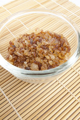 cup of sugar, rock brown sugar in a clear cup.