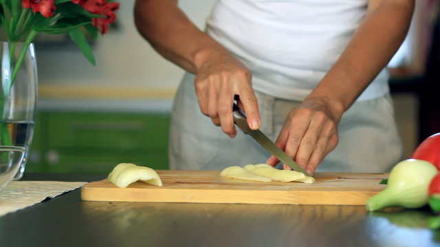 Female hands slicing white pepper, dolly shot