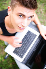 Closeup portrait of young student man using laptop and 3g usb mo