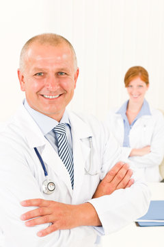 Medical team senior smiling male young woman
