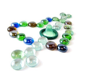 Stone mosaic with condom in the shape of a heart with an arrow