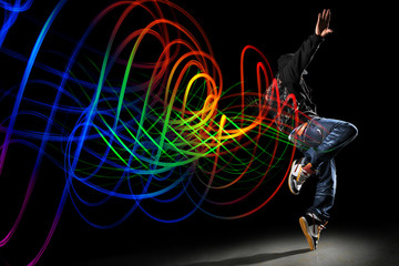 Dancer with Waves of Light Over Black Background