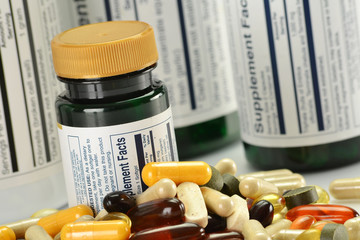 Composition with dietary supplement capsules and containers