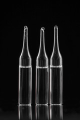 medical ampoules on black background