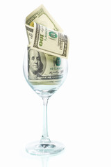 Fototapeta na wymiar Wine glass filled with dollar bills