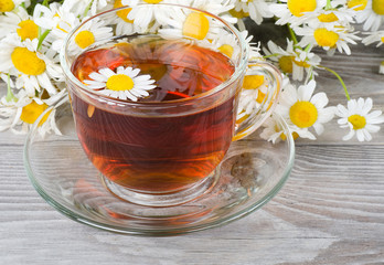Glass cup with a camomile tea