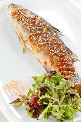 fried fish with fresh herbs and lemon