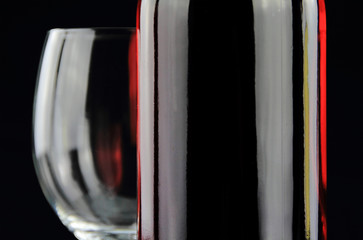 Bottle of red wine and a crystal wineglass